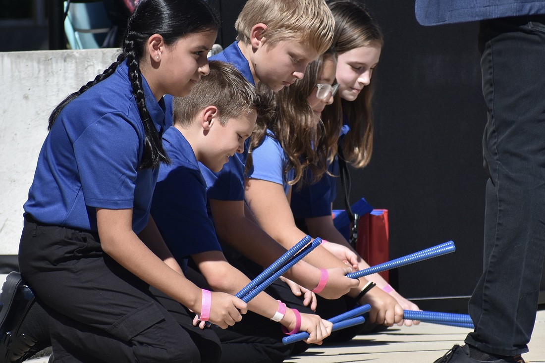 Fifth grader Ellah Nasr, fourth grader Nathan Rockwell, and fifth graders Peter Maslikhov, Evelyn Lambert and Hayden Oliva perform with the Ashton Elementary choir and soloists.