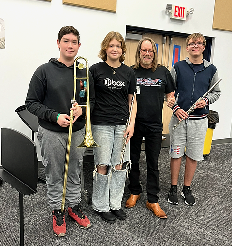 Anthony Wild (second from right) with Buddy Taylor Middle School students who received new instruments last year. Courtesy photo