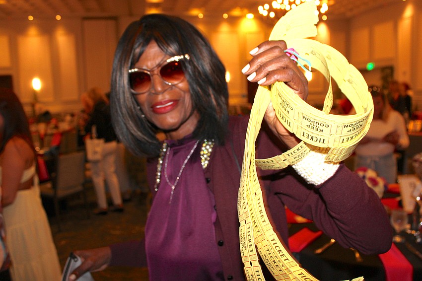 Sisterhood for Good's Barbara Williams is selling raffle tickets before Bingo begins at the Grove in Lakewood Ranch.