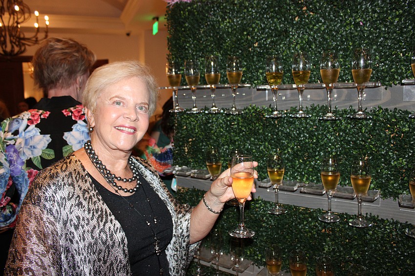 Mary Harper took advantage of the champagne wall that greeted guests when they came into the Grove.