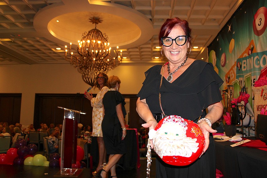 It's beginning to look like Christmas, as Darci Boutique owner Darci Jacob shows with this purse during Designer Bag Bingo.