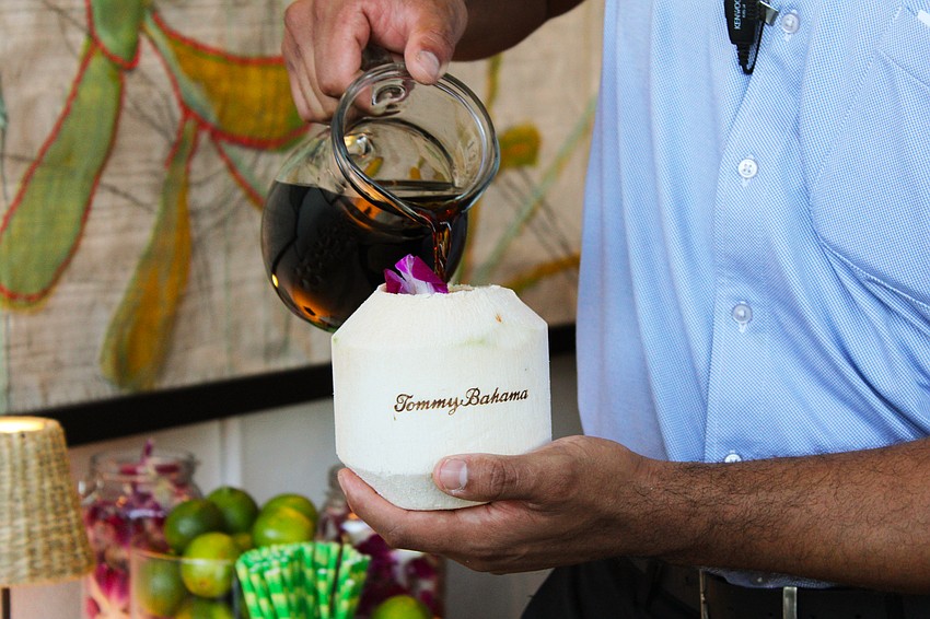 Andres Soto pours welcome drinks for those celebrating the reopening of the Tommy Bahama Restaurant & Bar on St. Armands Circle on Nov. 5.