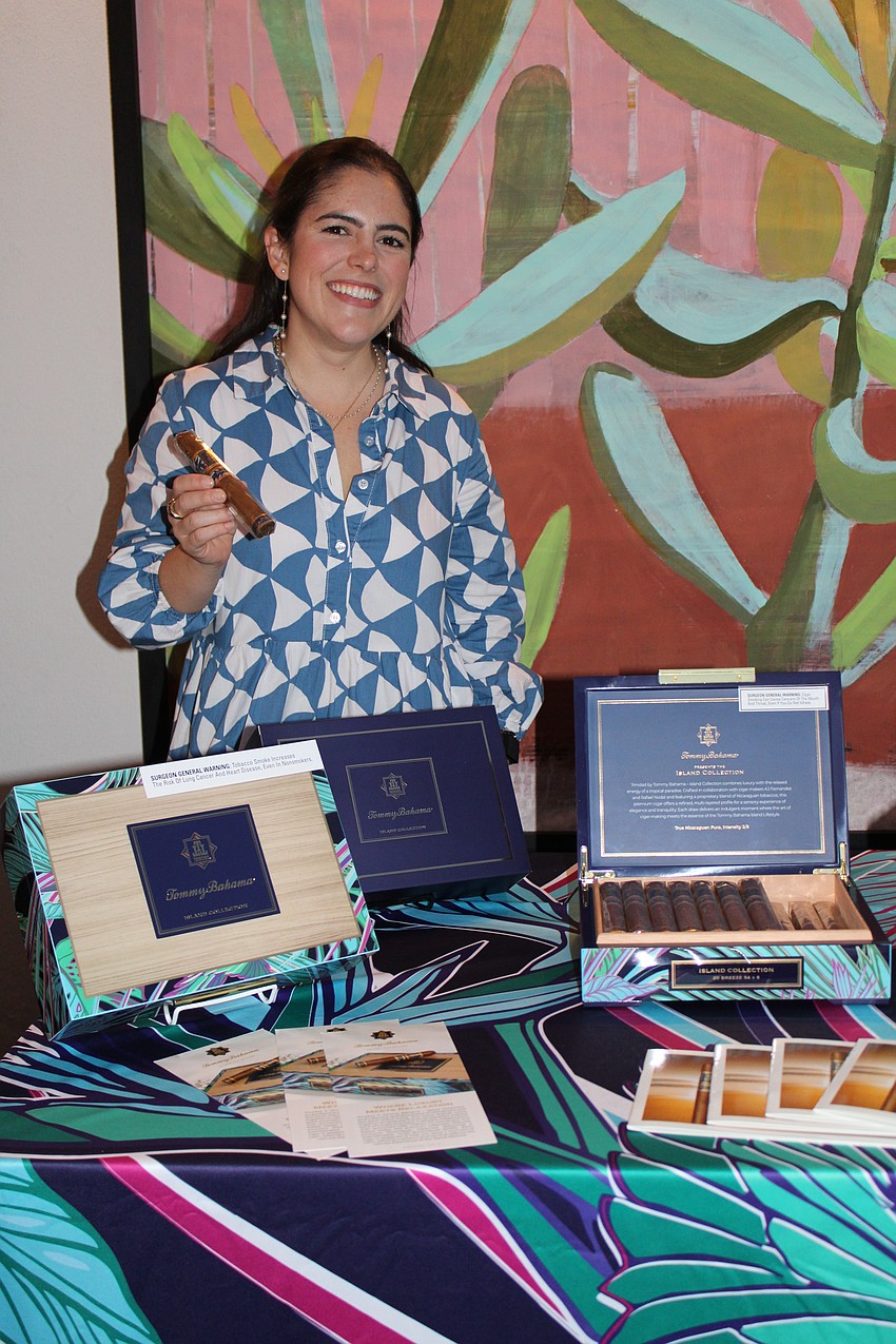 Brand manager Mariana Hinestrosa showcases the Tommy Bahama Island Collection of cigars, made with tobacco sourced from Nicaragua, at the grand opening of the Tommy Bahama Restaurant & Bar on St. Armands Circle.