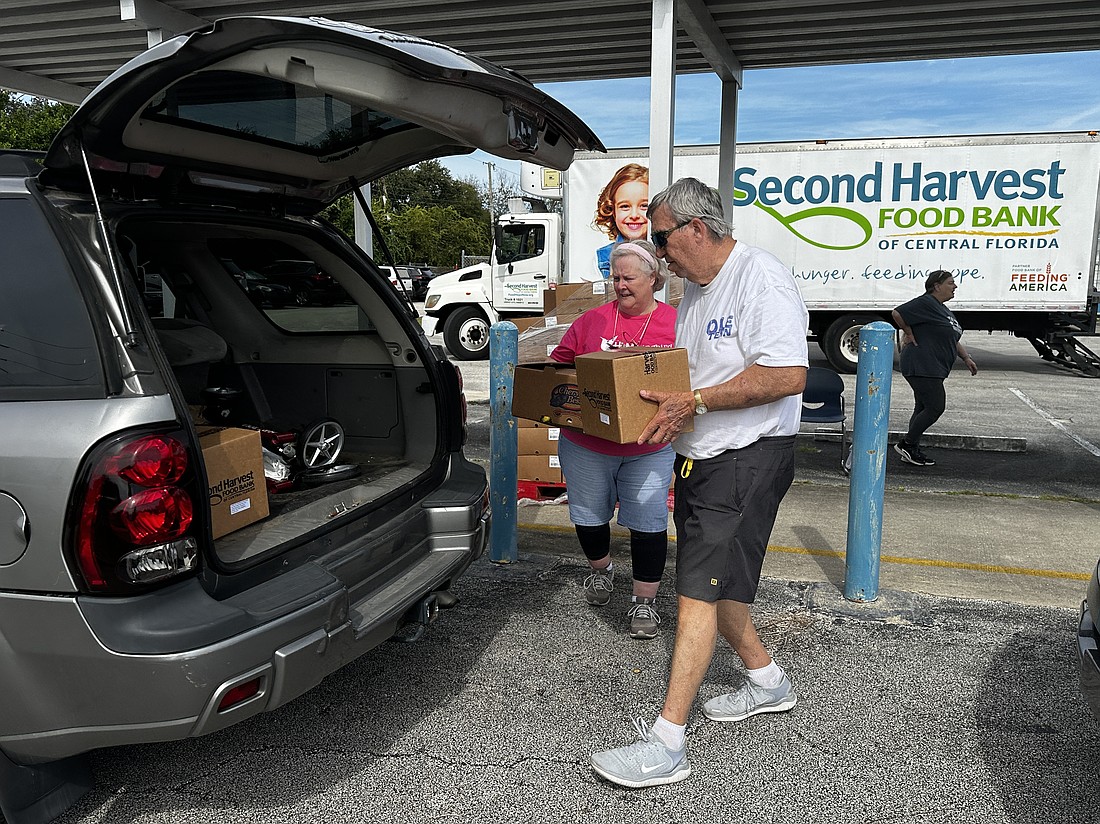 A volunteer loads food into a resident's trunk. Courtesy photo