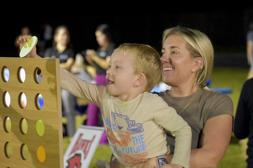 Wyatt Gormley, 3, and his mother Jessica Gormley, play a game of Connect Four.