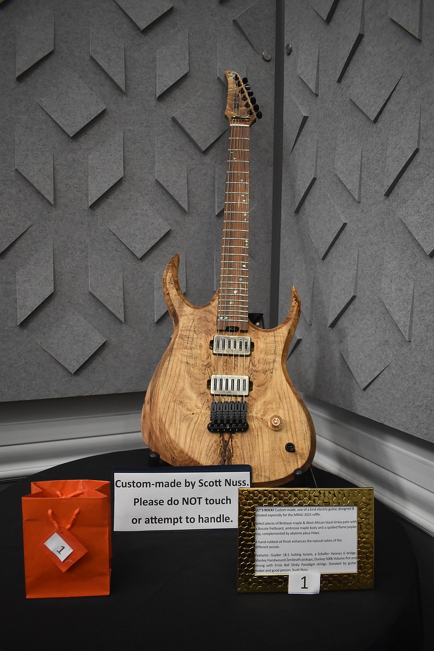 Custom made by Ringling College graduate Scott Nuss, this ambrosia maple electric guitar is a one-of-a-kind raffle item.