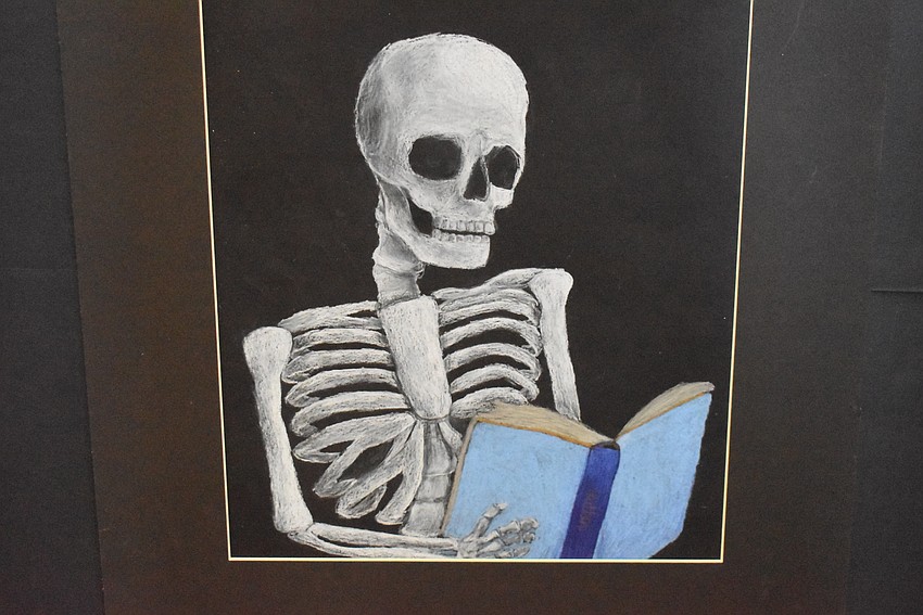Carlos E. Haile Middle School's Madelyn Sutton displays this drawing of a skeleton. She used prisma colored pencils to create the drawing, which took over a week to finish.