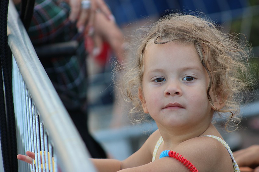 Sarasota 3-year-old Brielle Lapidus looks down the parade route to see what's coming next.