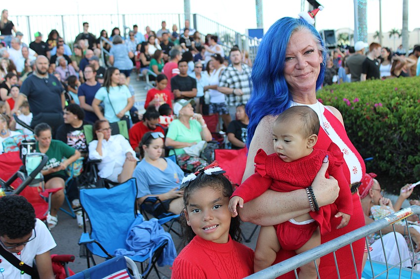 Palmetto 5-year-old Pynelopee Redmond and 5-month-old Maizee were brought to the Santa's Grand Arrival Parade by their grandmother, April Johnson.