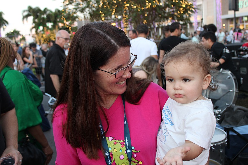 Before Sarasota County Commissioner Teresa Mast fills her duties Nov. 8 as a Santa's Grand Arrival Parade judge, she visits with her grandson James Diaz.