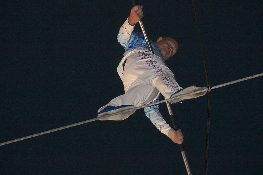 Nik Wallenda concentrates on each step as he walks the high wire above the 2025 Santa's Grand Arrival Parade crowd at UTC Nov. 8. He completed a criss cross stunt with his sister, Lijana Wallenda.