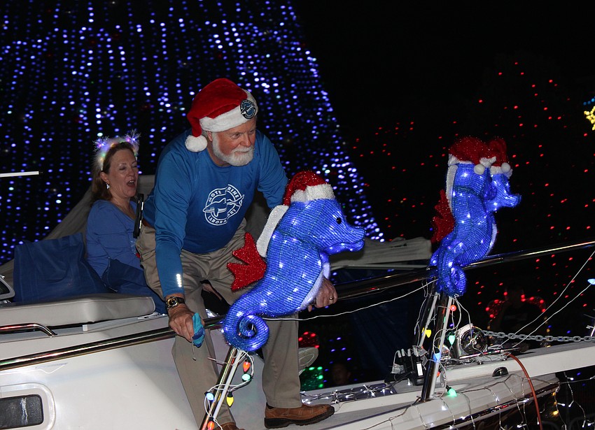 That's not Santa. It's Mote Marine CEO Michael Crosby riding a float in the 2025 Santa's Grand Arrival Parade at UTC.