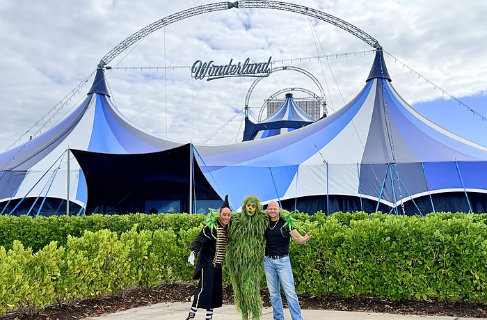 Daredevil clown Johnny Rockett, the Grinch and superstar aerialist Nik Wallenda pose in front of Wonderland's new tent near UTC.