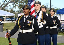 Sarasota High School Color Guard members Madisen Dwarika, Lindsey Nelson, Cyleigh Harrington and Camila Cavazos prepare to start off the celebration of Veterans Day and the Town of Longboat Key's 70th anniversary on Nov. 8 at the Town Center Green.