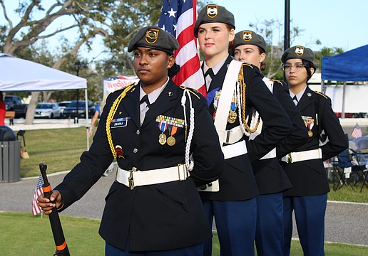 Sarasota High School Color Guard members Madisen Dwarika, Lindsey Nelson, Cyleigh Harrington and Camila Cavazos prepare to start off the celebration of Veterans Day and the Town of Longboat Key's 70th anniversary on Nov. 8 at the Town Center Green.