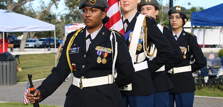 Sarasota High School Color Guard members Madisen Dwarika, Lindsey Nelson, Cyleigh Harrington and Camila Cavazos prepare to start off the celebration of Veterans Day and the Town of Longboat Key's 70th anniversary on Nov. 8 at the Town Center Green.