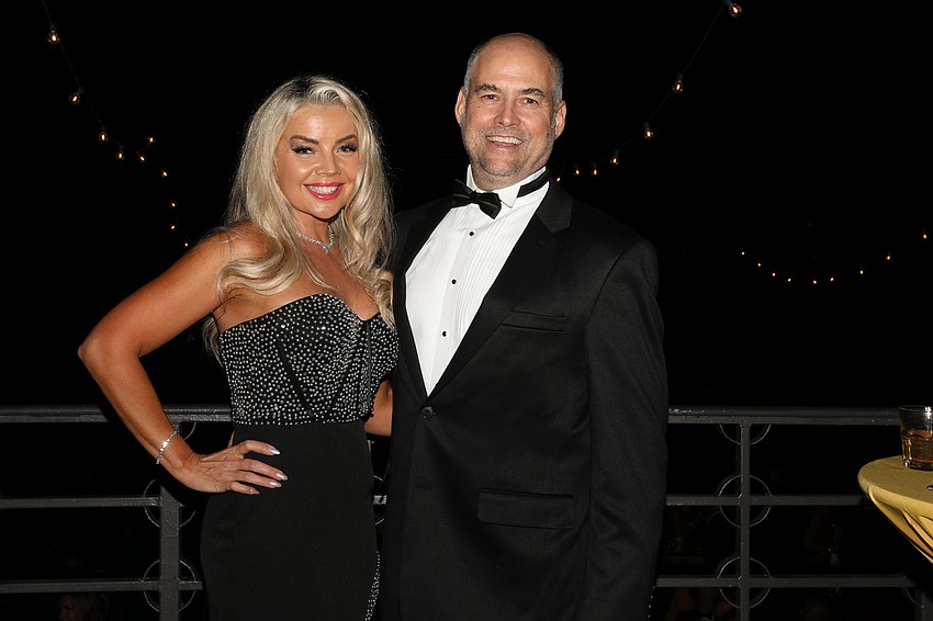 Olga and Doug Montanus enjoy the sun setting over Sarasota Bay.