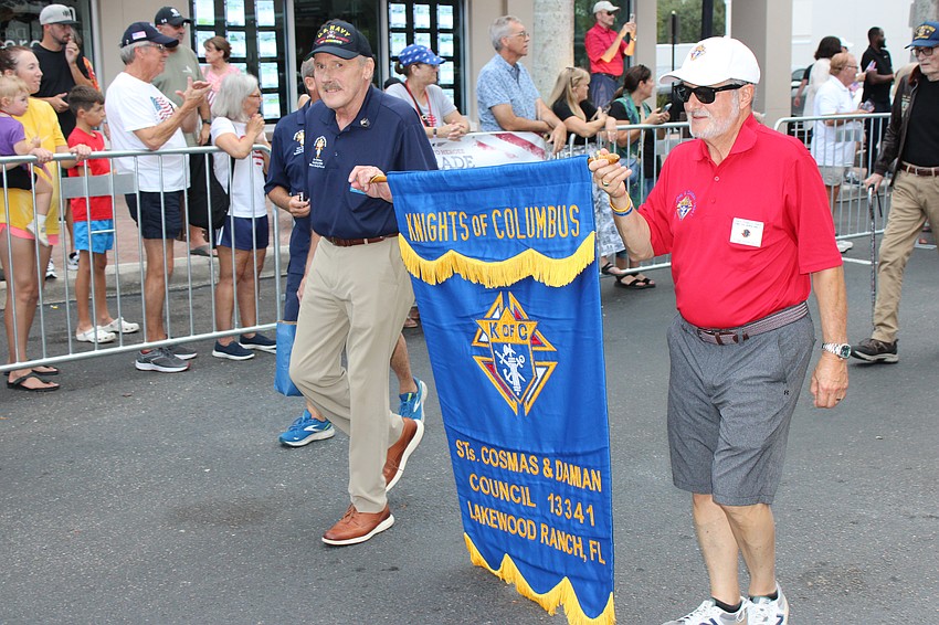 John Joly and Tom Rokosz of the Knights of Columbus lead their group in the Tribute to Heroes Parade in Lakewood Ranch.