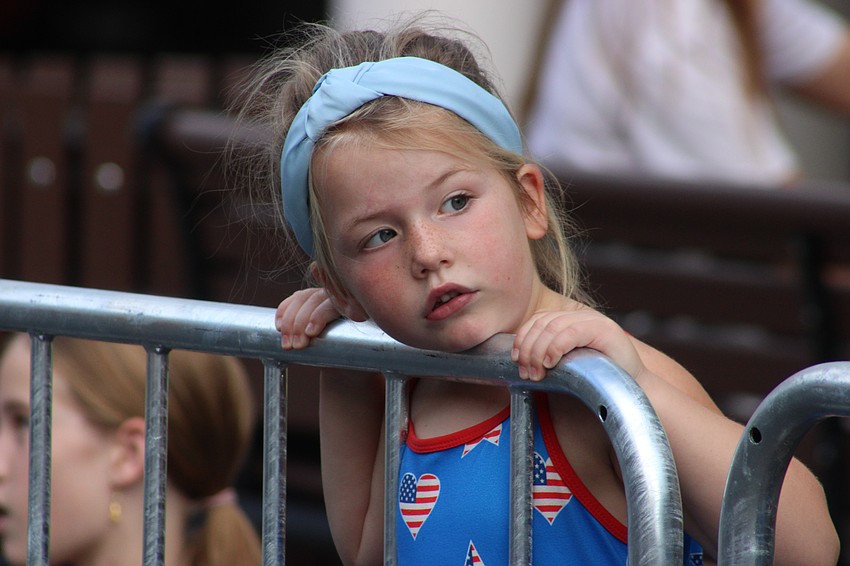 Lakewood Ranch 4-year-old Isabelle Fant looks to see what is coming next down Lakewood Main Street during the Tribute to Heroes Parade Nov. 9.