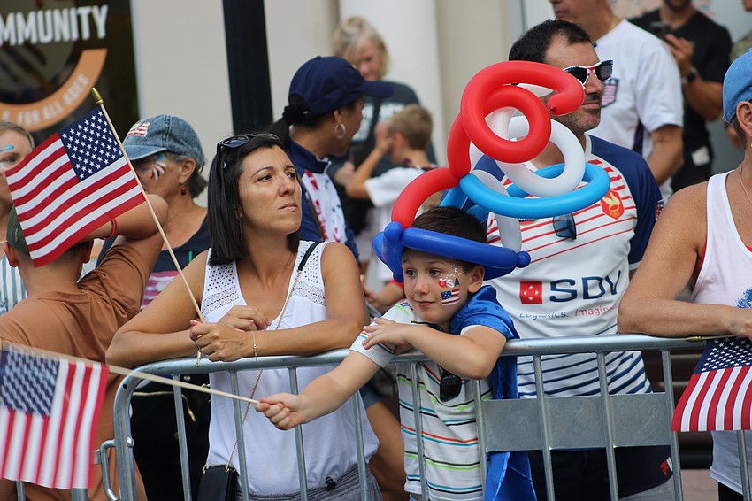 Lakewood Ranch 8-year-old Alexandre Cottalorda has a balloon hat that is longer than his flag.