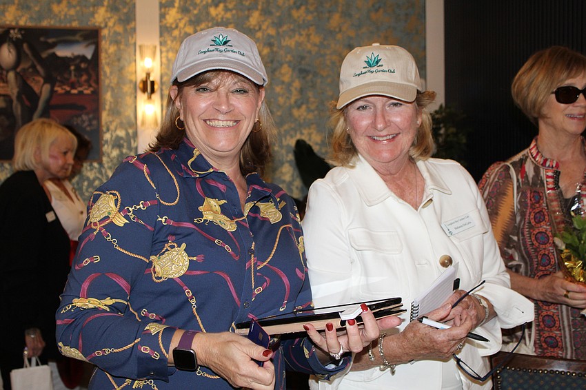 Longboat Key Garden Club President Melanie Dale and Melanie DeCarlo sport the club's stylish new caps at the welcome back party on Nov. 5 at Café on St. Armands.