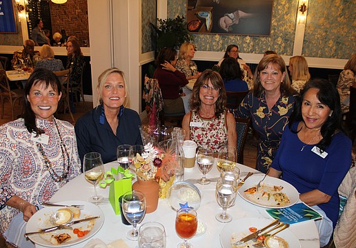 Debra Sauers, Mimi Dolan, Sharon Meier, Melanie Dale and Patricia Geldermann discuss the season's upcoming events at the Longboat Key Garden Club's welcome-back luncheon on Nov. 5 at Café on St. Armands.