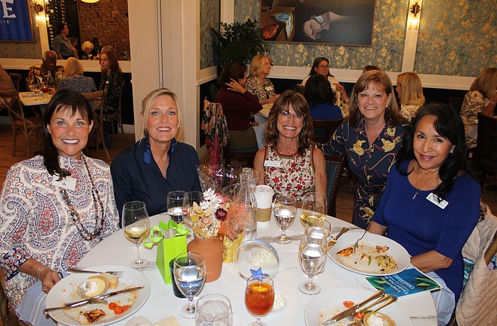 Debra Sauers, Mimi Dolan, Sharon Meier, Melanie Dale and Patricia Geldermann discuss the season's upcoming events at the Longboat Key Garden Club's welcome-back luncheon on Nov. 5 at Café on St. Armands.