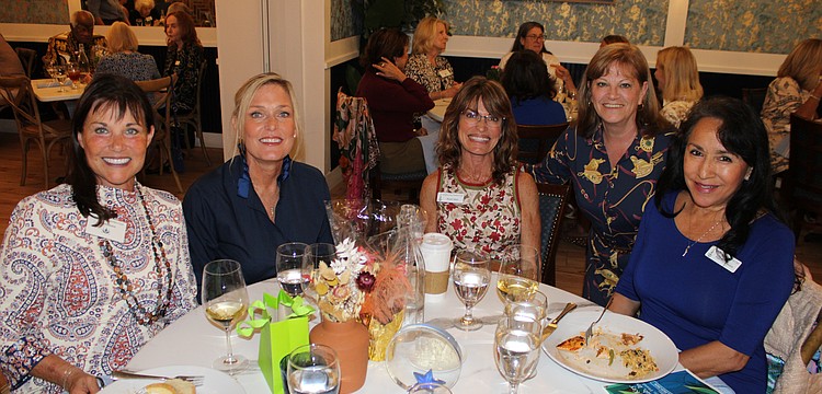 Debra Sauers, Mimi Dolan, Sharon Meier, Melanie Dale and Patricia Geldermann discuss the season's upcoming events at the Longboat Key Garden Club's welcome-back luncheon on Nov. 5 at Café on St. Armands.