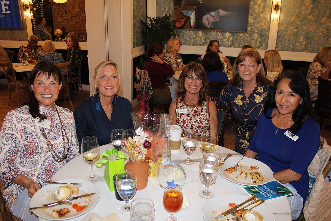 Debra Sauers, Mimi Dolan, Sharon Meier, Melanie Dale and Patricia Geldermann discuss the season's upcoming events at the Longboat Key Garden Club's welcome-back luncheon on Nov. 5 at Café on St. Armands.