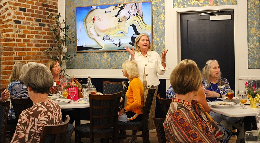 Longboat Key Garden Club member Melanie DeCarlo explains how she worked with a locally based embroiderer on the design for the club's new hats.