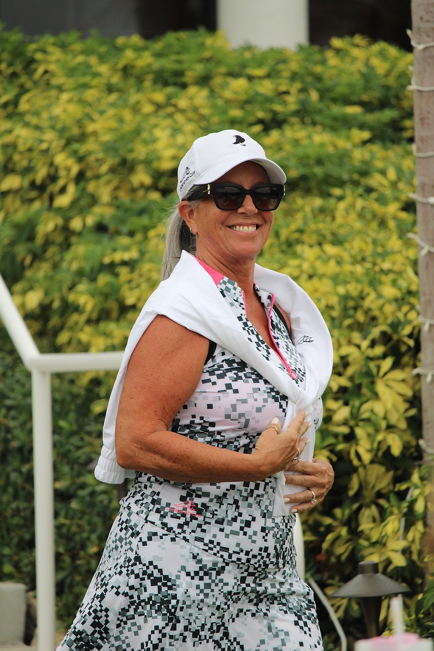 Michelle Papier is all smiles while sporting her golf set at the Longboat Key Club Women's Nine Hole Golf Association fashion show and season opener.
