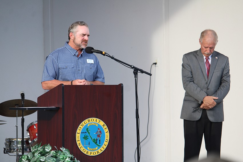 Rev. Brock Patterson of Longboat Island Chapel, with Town Manager Howard Tipton, offers the opening invocation for the Veterans Day event on Longboat Key.