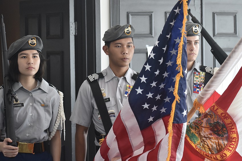 Sarasota Military Academy students Vivienne Sarabia, a senior, Joey Miguel, a junior and Zach Jewell, a senior serve in the color guard.