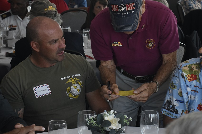 Linnie Longenecker helps Tom Smith as he determines the youngest Marine.