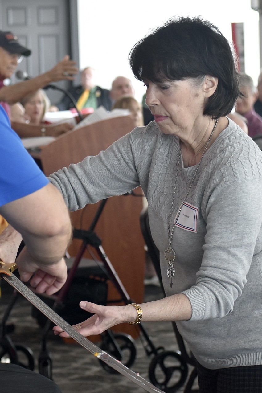 Becky Metcalfe cuts the cake.