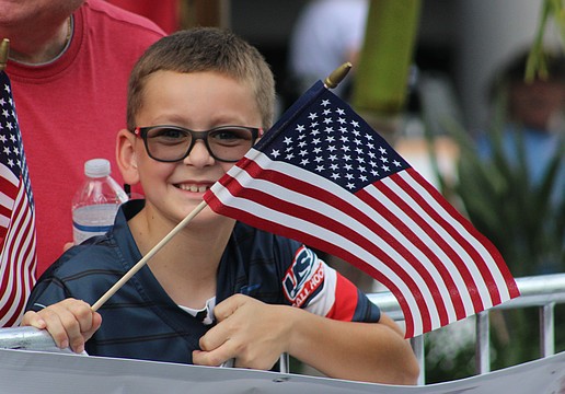 Lakewood Ranch's Vincent Van Slyck keeps his flag waving during the Tribute to Heroes Parade Nov. 9 at Main Street at Lakewood Ranch.