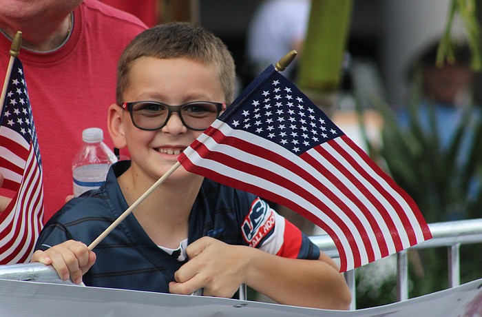 Lakewood Ranch's Vincent Van Slyck keeps his flag waving during the Tribute to Heroes Parade Nov. 9 at Main Street at Lakewood Ranch.