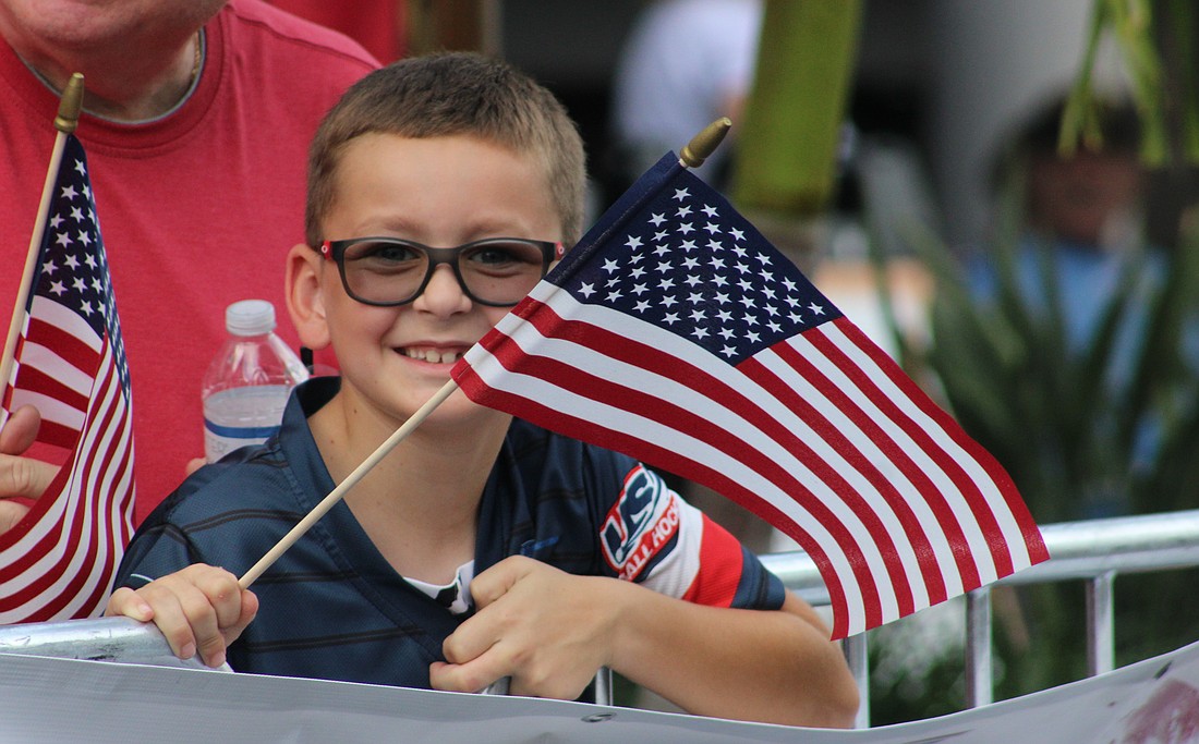 Lakewood Ranch's Vincent Van Slyck keeps his flag waving during the Tribute to Heroes Parade Nov. 9 at Main Street at Lakewood Ranch.