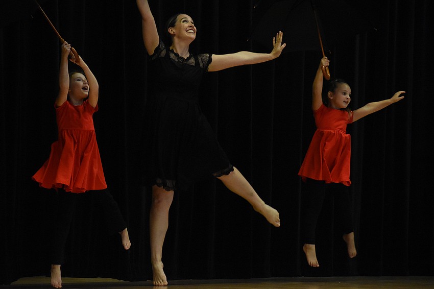 Theadora Snyder, instructor Elisha Byerly, and Brinley Remelski perform 