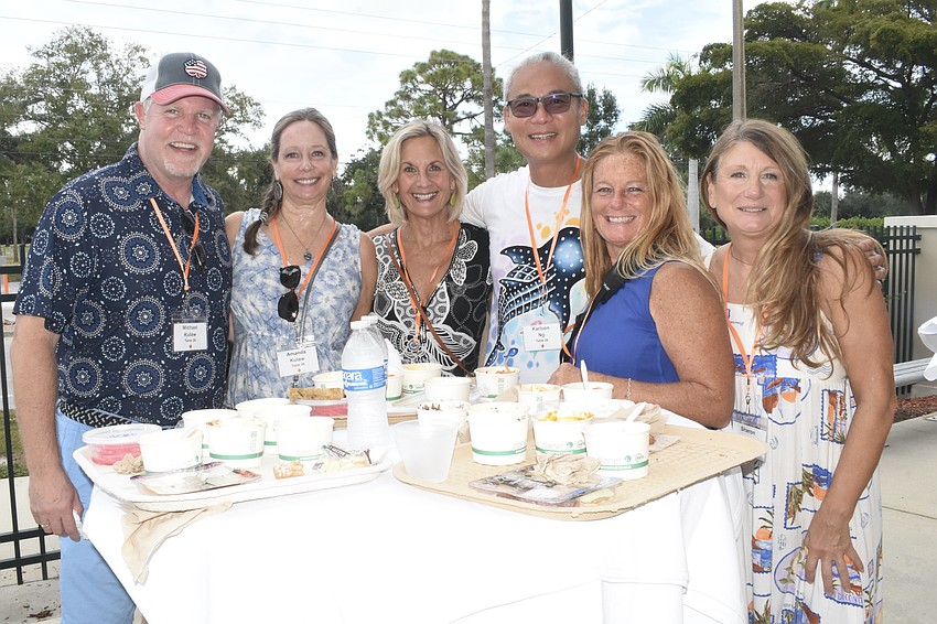 Michael Kulaw and Amanda Kulaw, Lee Ann Moody, Karloon and Karyn Ng, and Sharon Kane gather around a table.