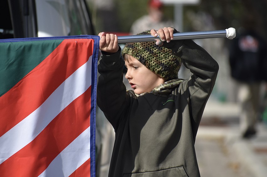 Kindergartener Henry Schaefer helps out Venice Middle School with a banner.