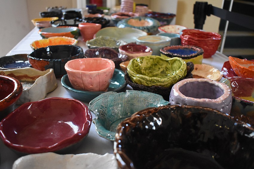 Bowls made by kids are set out for purchase.