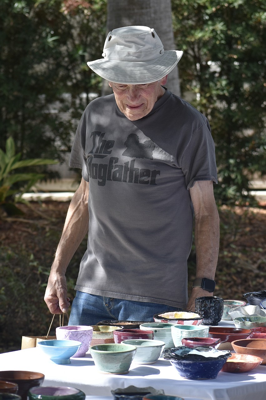 Michael Koolkin browses the bowls on display.