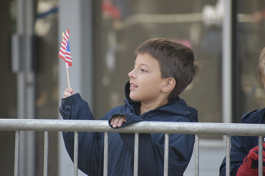Rafaello Fainelli, 8, watches the parade.