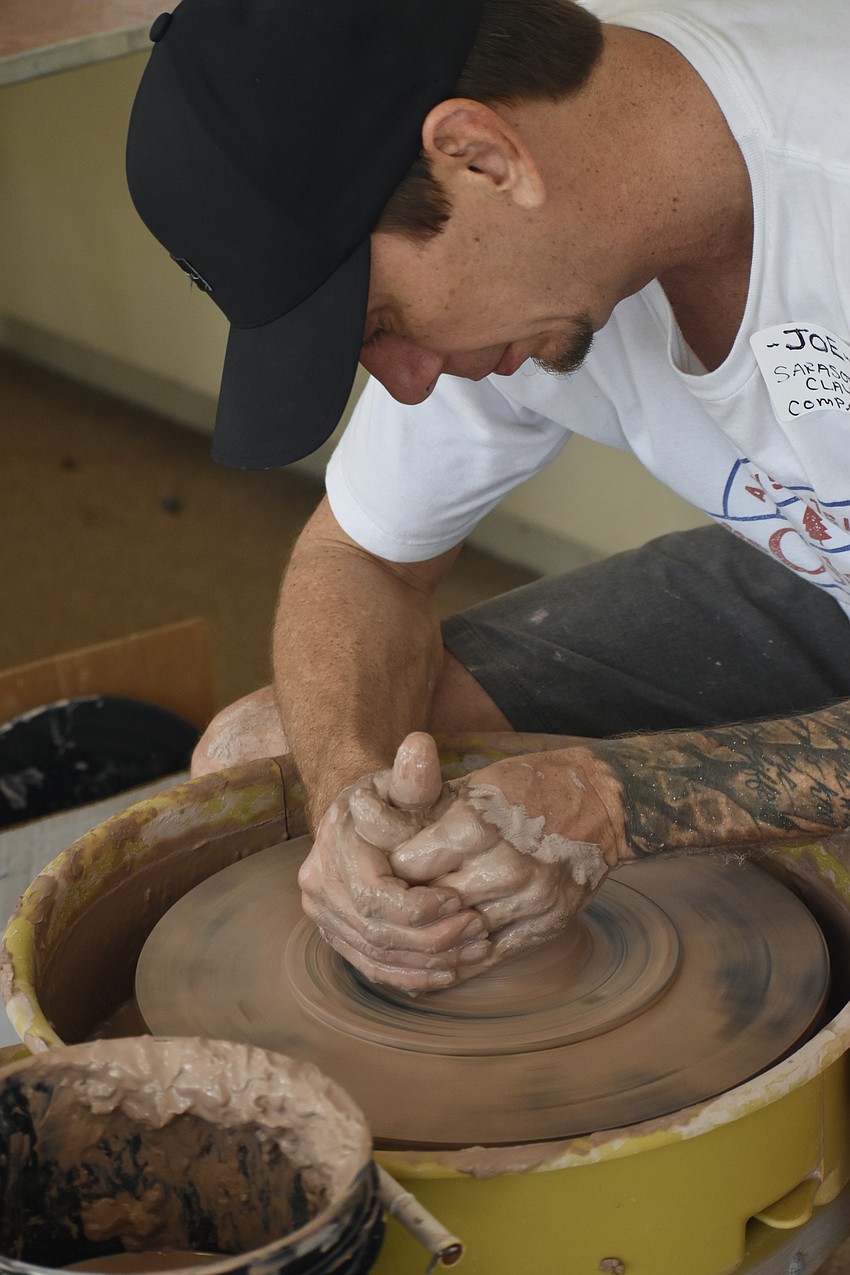 Joseph Matthews of Sarasota Clay Company creates a bowl on site at the event.