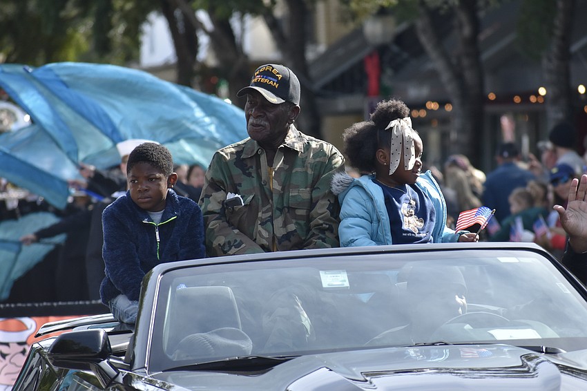 Korean War veteran James Williams (center) rides in the parade with his nephew Carson Ward, 7, and Taylin Saunders, 6.