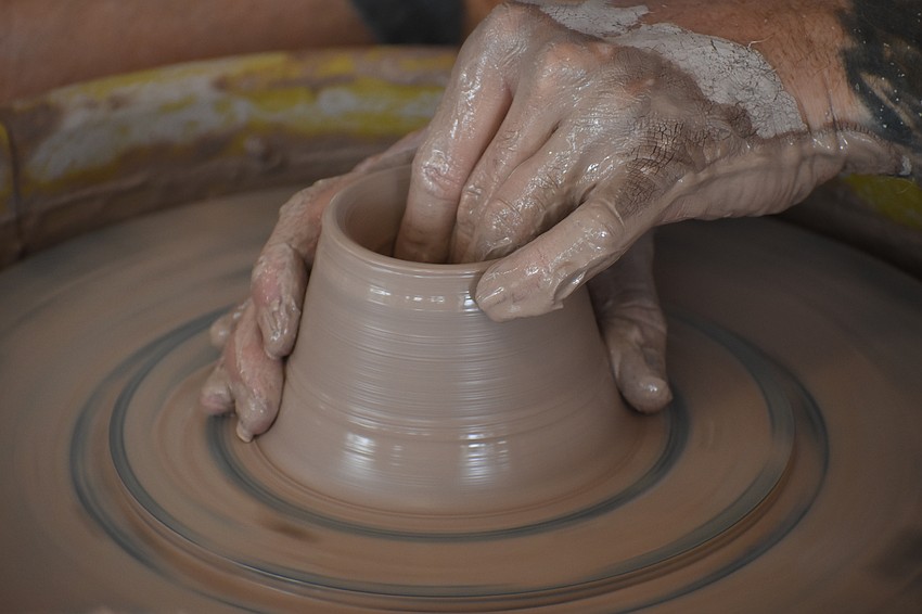 Joseph Matthews of Sarasota Clay Company creates a bowl on site at the event.