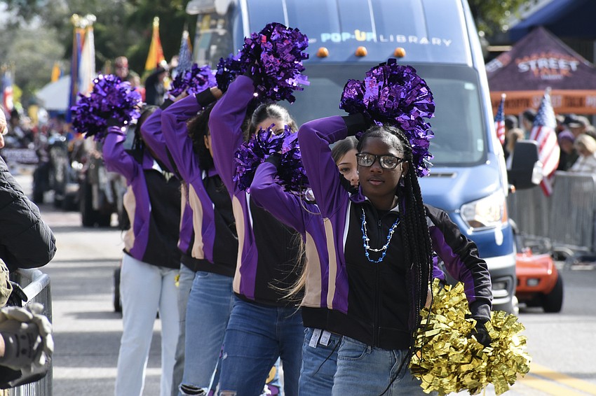 Cheerleaders from Booker High School march in the parade.