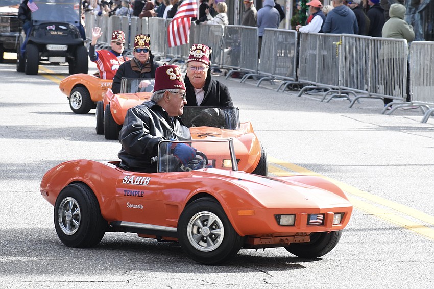 Miniature cars from Sahib Shriners make their way along the route. Front to back: Frank Metheny, Billy Payne, David Walters and Mark Nelson.