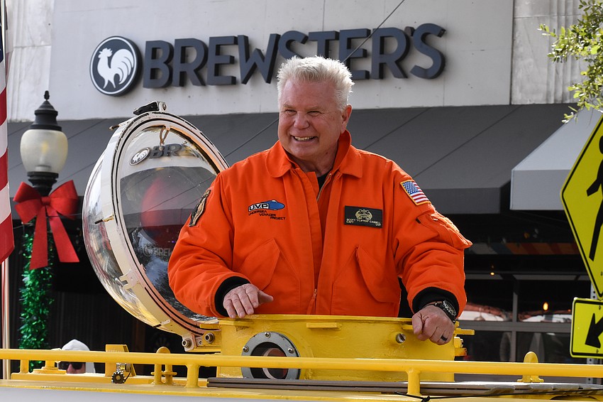 Explorer, underwater filmmaker and former  U.S. Army combat medic Scott Cassell enjoys the parade from a submarine.